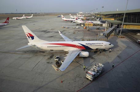 Ground staff work on a Malaysia Airlines plane at Kuala Lumpur International Airport in Sepang, Mala