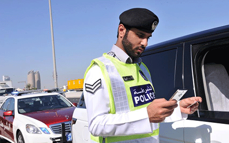 UAE police checking driver's license at night